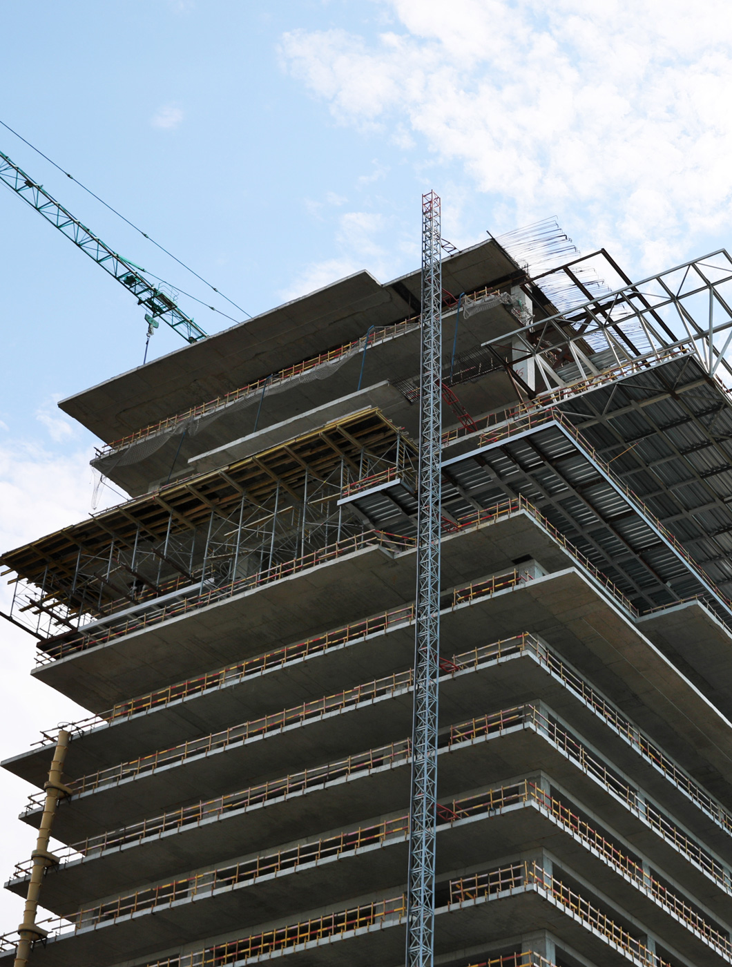 multistory-building-construction-against-cloudy-sky-low-angle-view